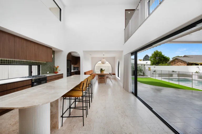 Modern kitchen and dining area with pool view
