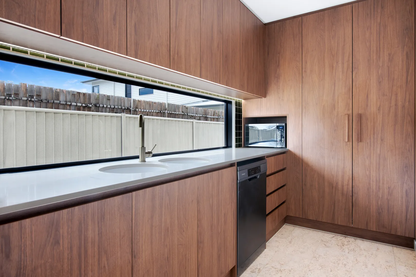 Modern kitchen with wood cabinets and large window