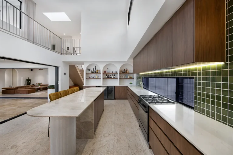 Modern kitchen interior with bar counter and shelves.