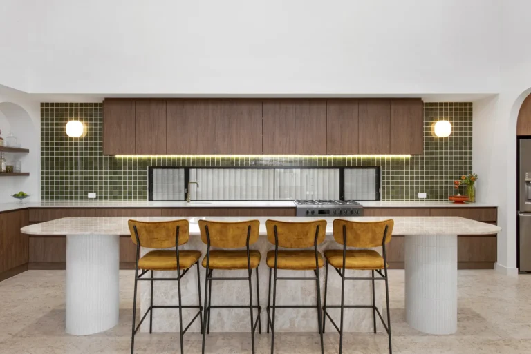 Modern kitchen with island and barstools.