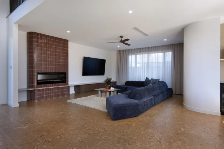 Modern living room with sofa and fireplace.
