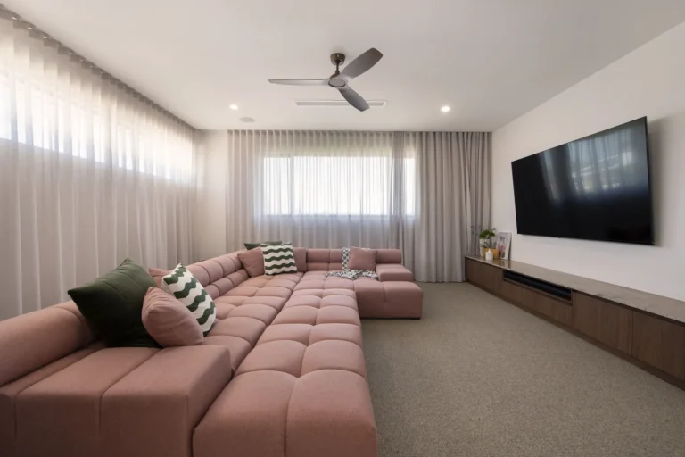 Modern living room with large pink sofa.