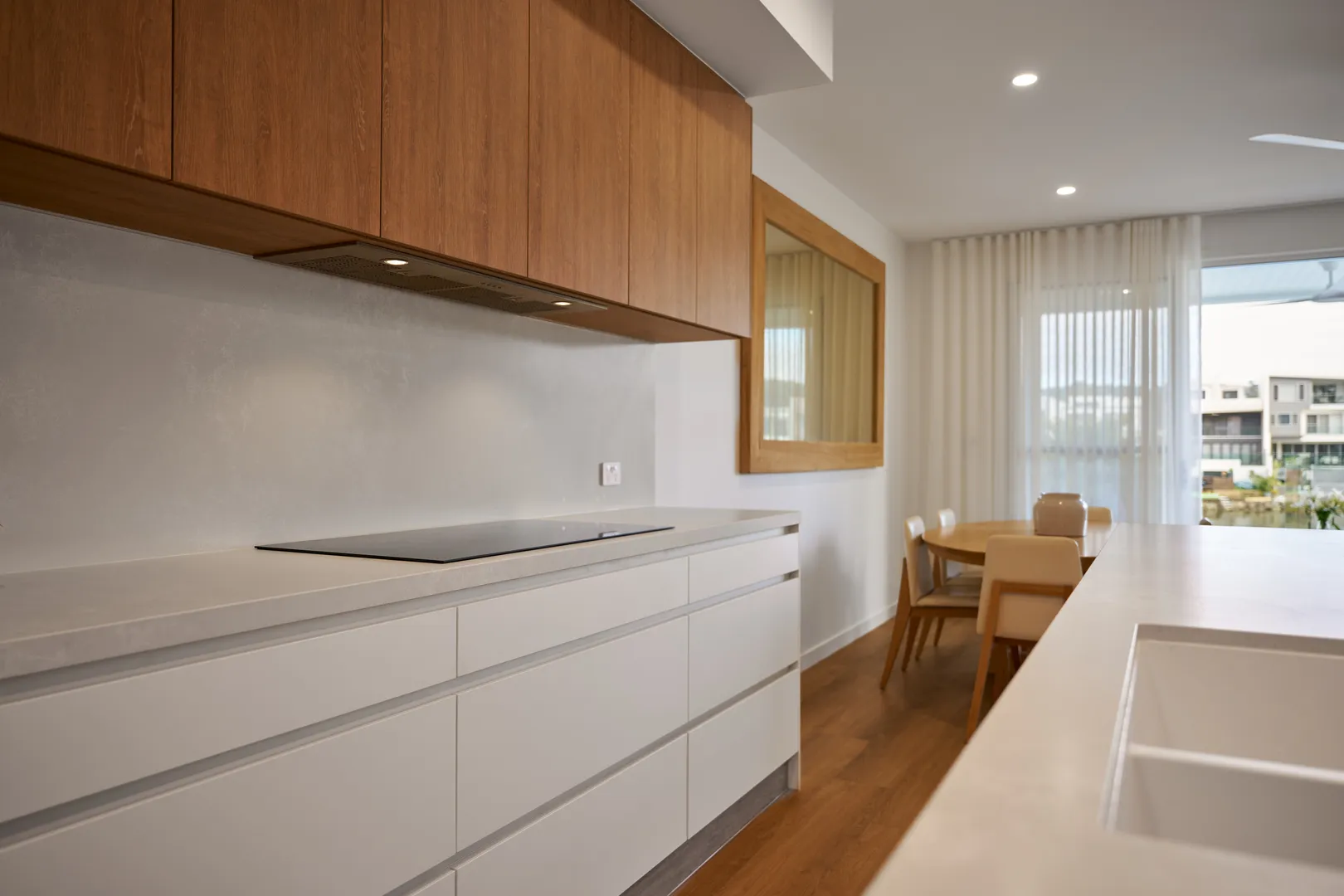 Modern kitchen with wooden cabinets and dining table