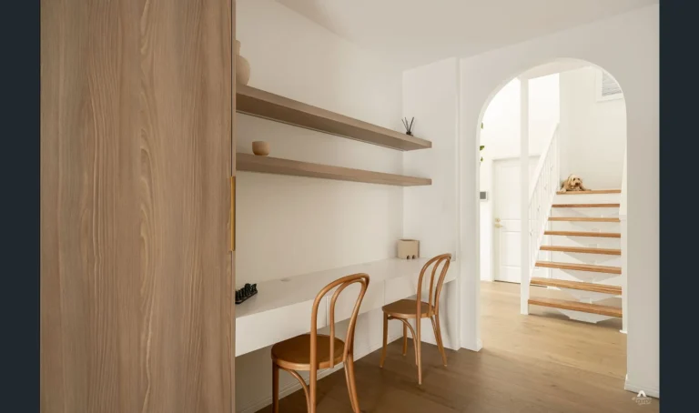 Modern home office with wooden stairs and dog